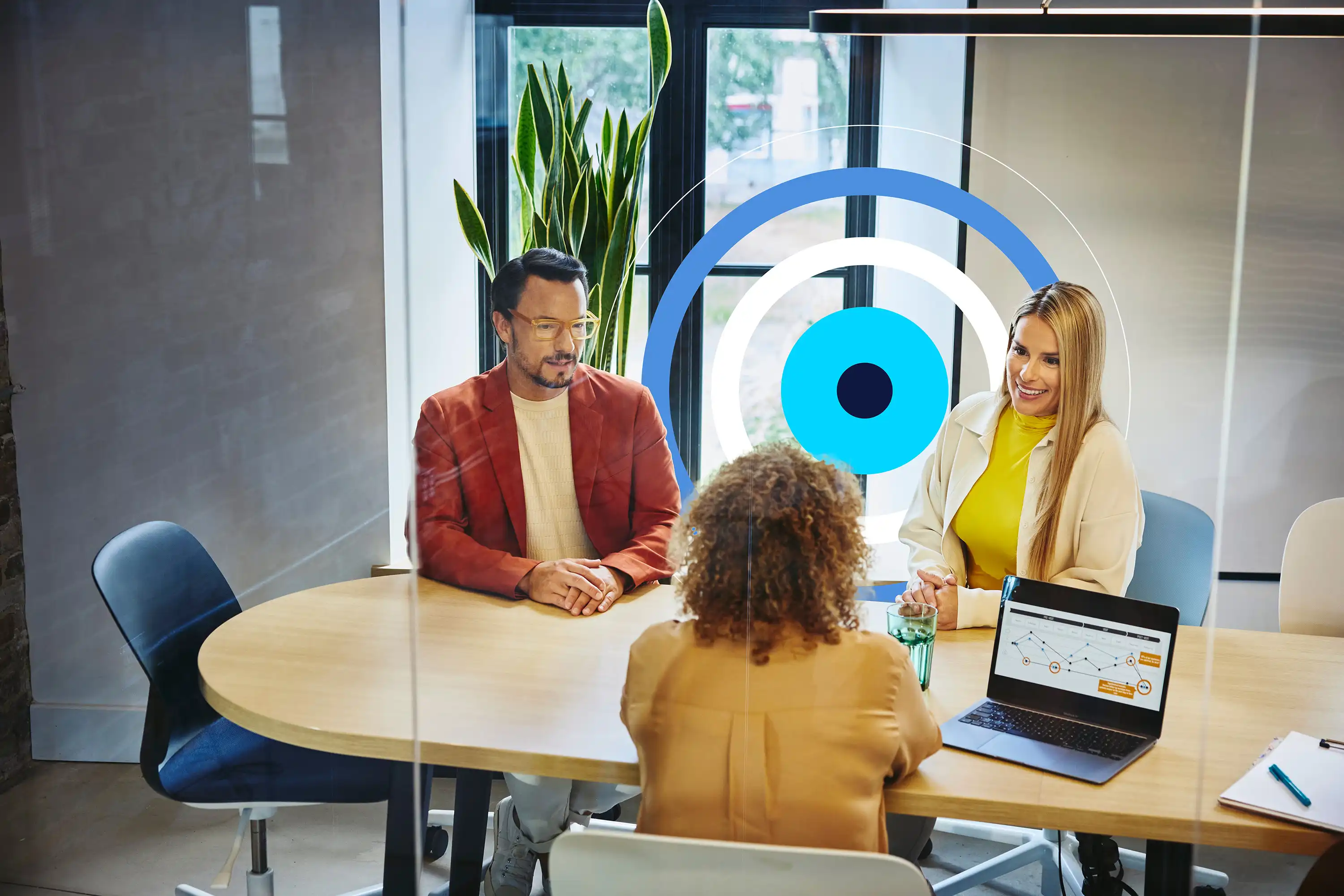 Three professionals meeting around a table in an office